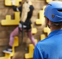 climbing instructor watching girl climbing