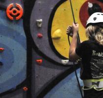 person belaying at a climbing wall