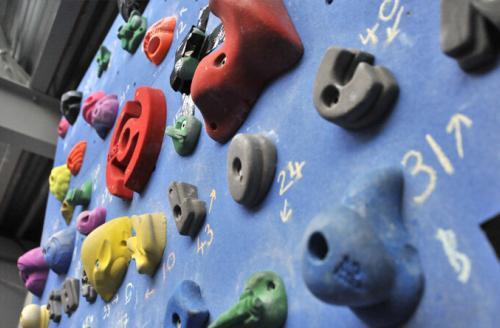 closeup of climbing holds on indoor wall