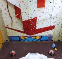 view looking down from the top of a high indoor climbing wall