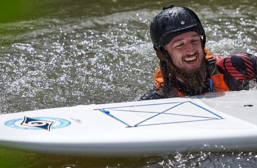smiling paddle boarder in the water