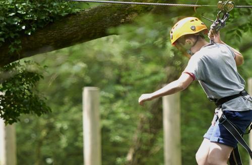 boy on treetops ropes course