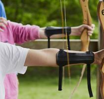 boy shooting a bow and arrow