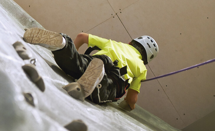 young person on a climbing wall