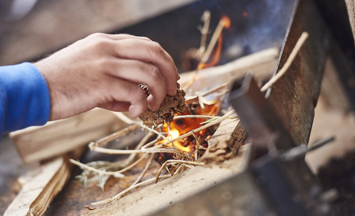 close up of starting a fire with sticks