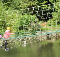 group of people on a cargo net across river