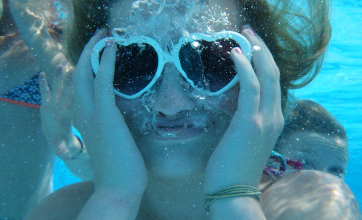 underwater view of girl with sunglasses on