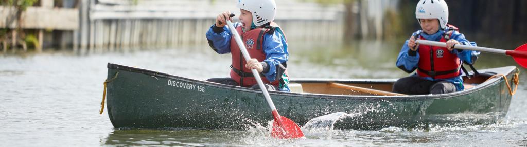 two boys enjoying canoeing