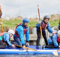 group of people on a large paddle board