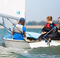 young people sailing a dinghy