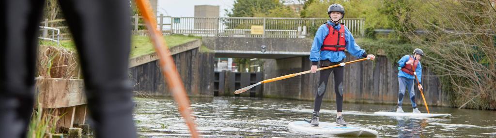 boys stand up paddle boarding