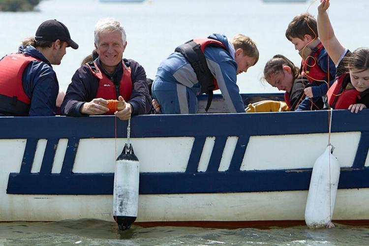 children catching crabs from a boat