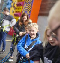 Family putting on climbing harnesses